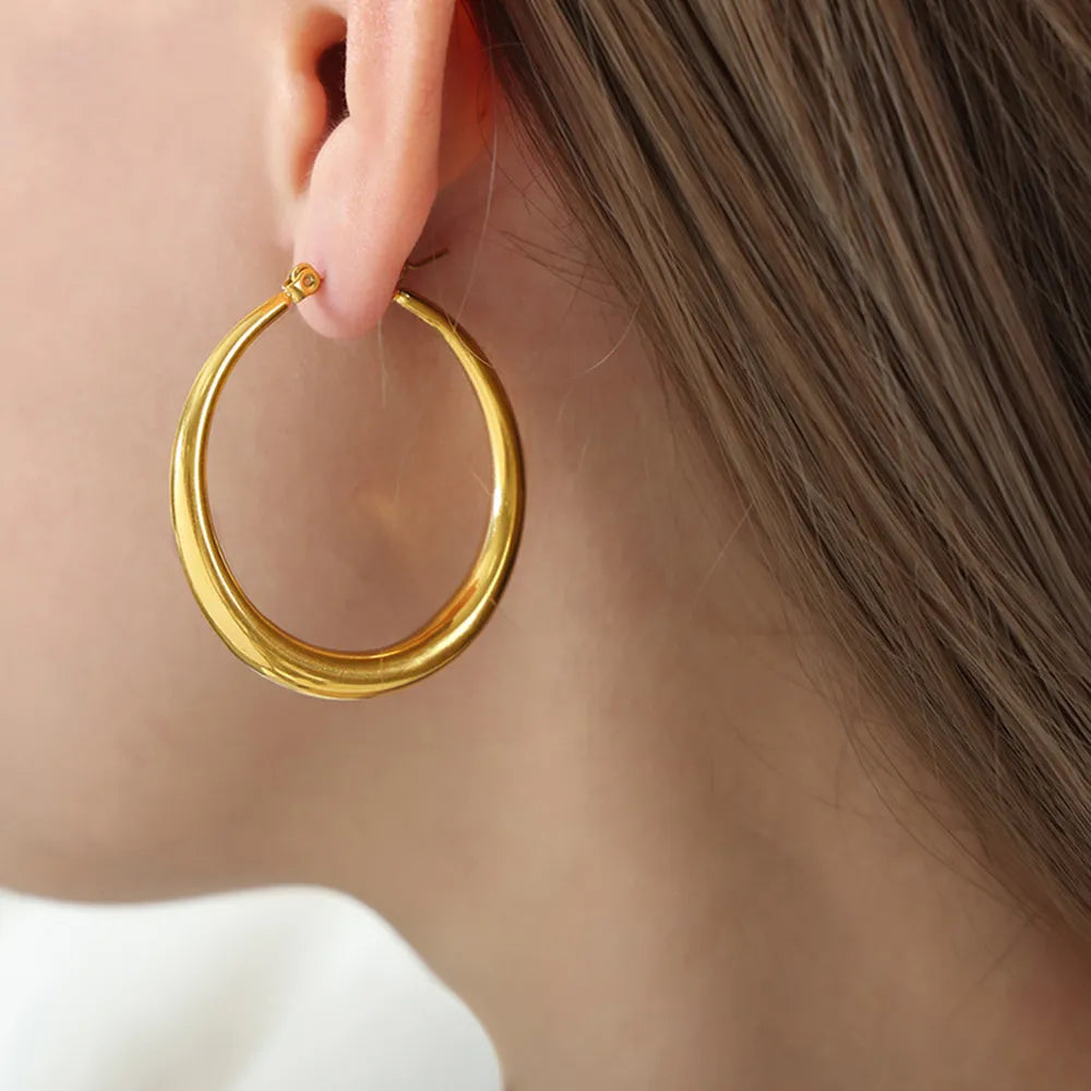 Woman wearing 18K gold-plated stainless steel hoop earrings for everyday wear Side View