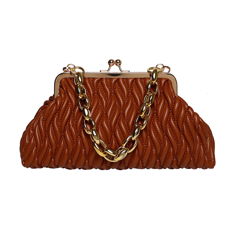 Brown textured leather clutch handbag with gold chain handle on a white background