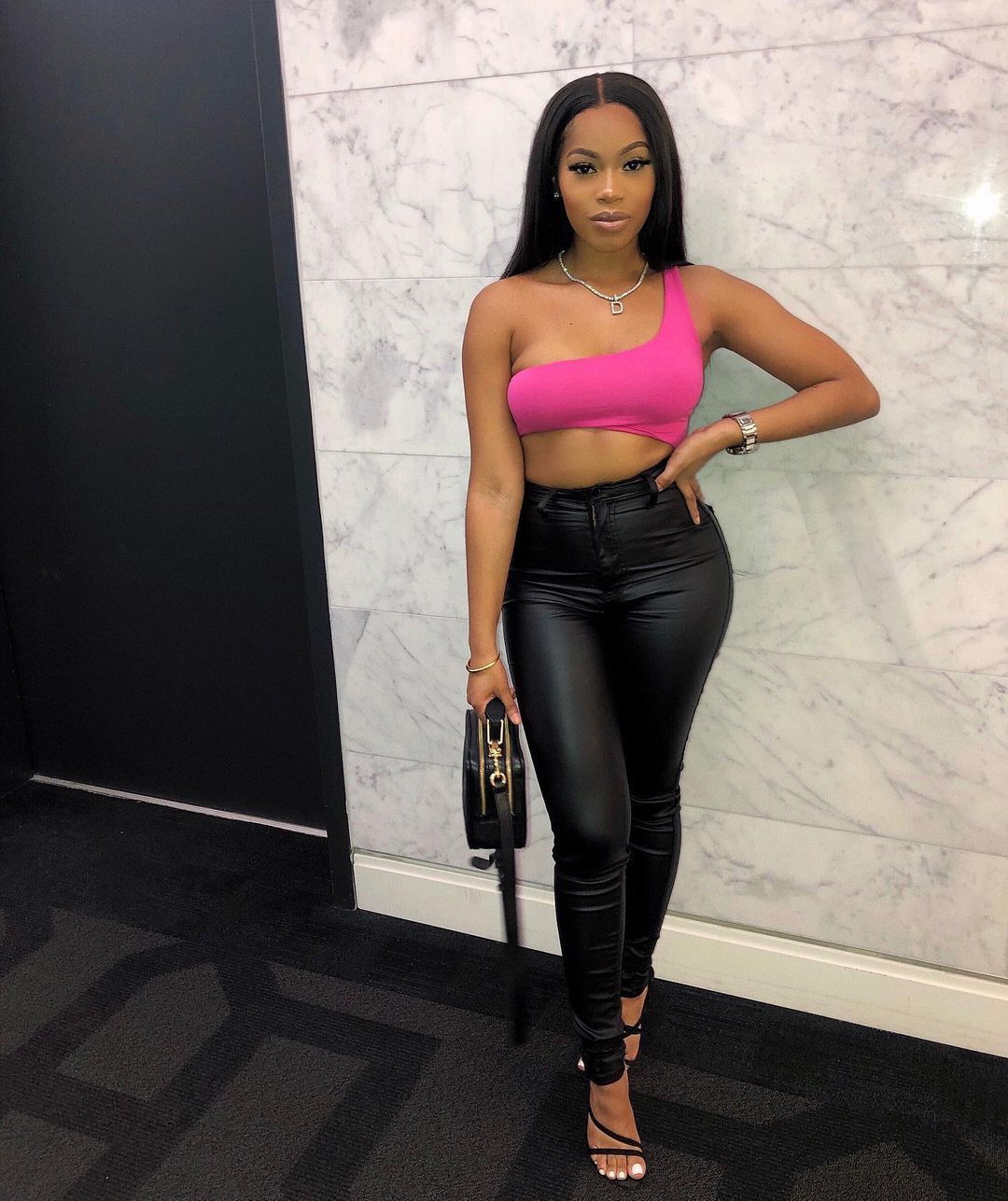 Woman in a black faux leather skinny leg pants