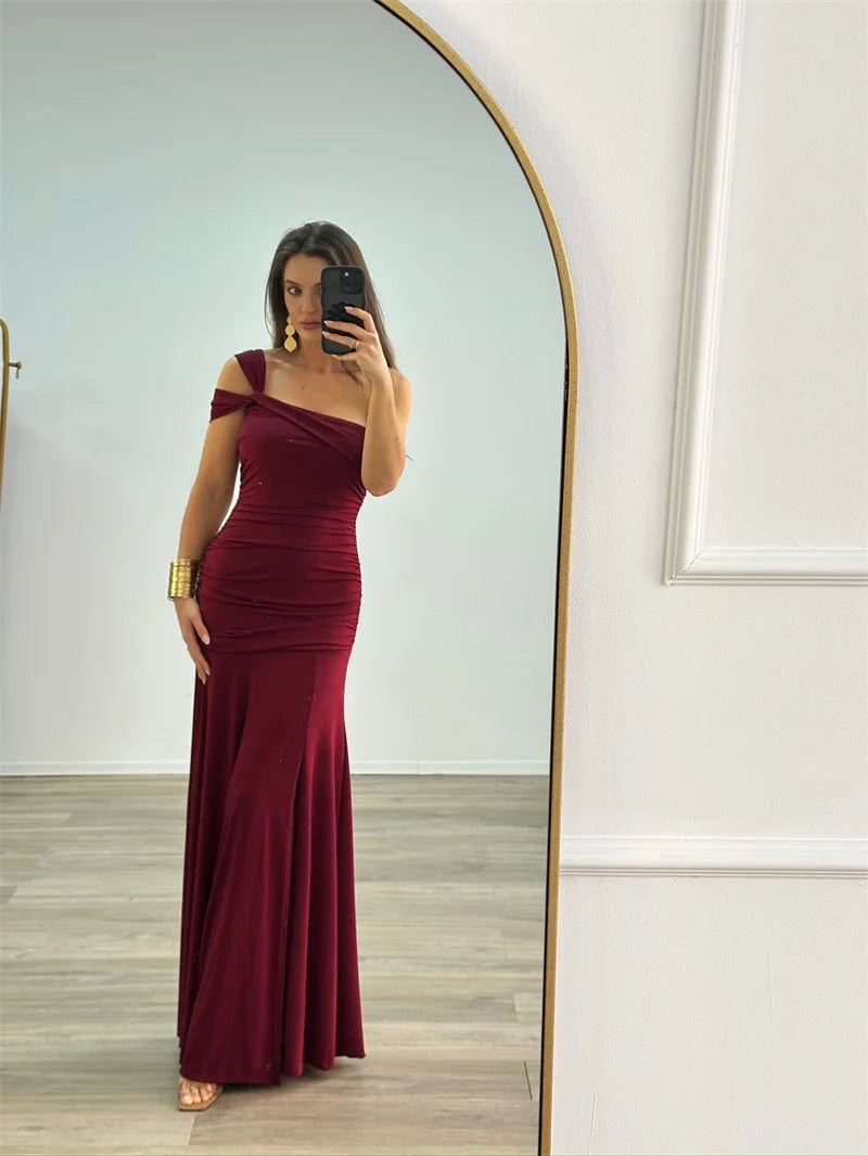 woman wearing elegant one-shoulder bodycon burgundy maxi dress