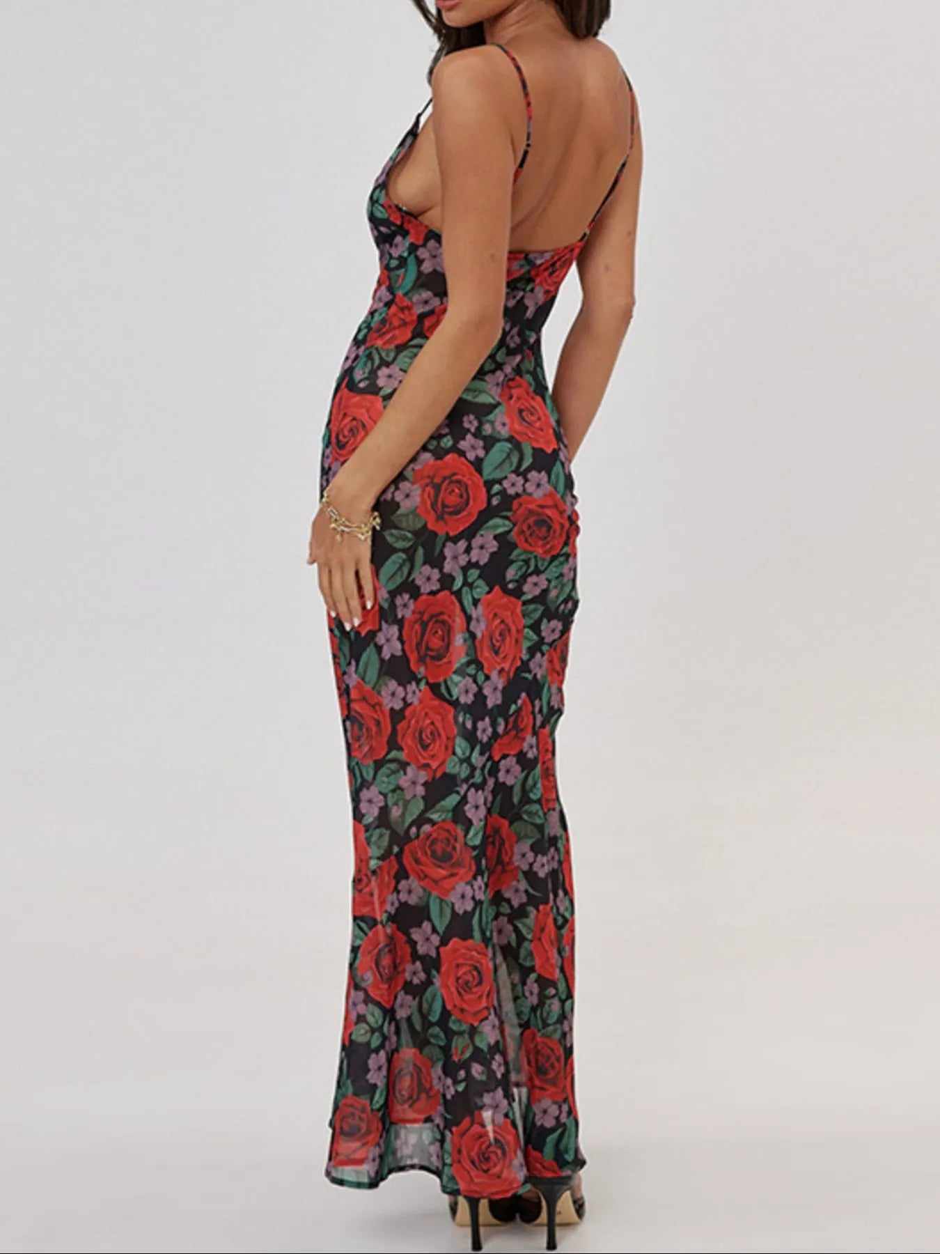 woman wearing floral patterned maxi summer dress on a white background