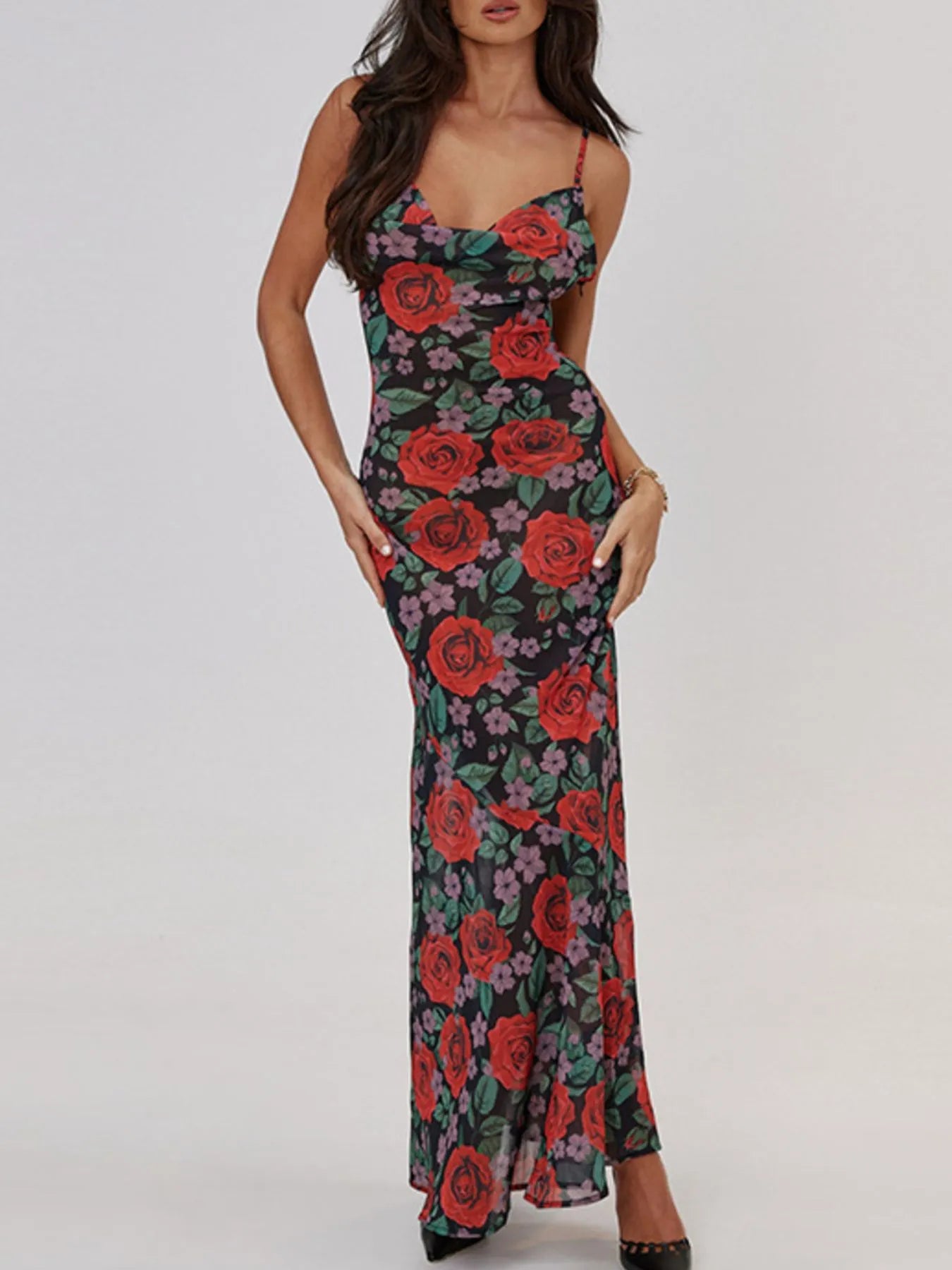 Woman wearing a floral bodycon summer dress with red roses on a white background