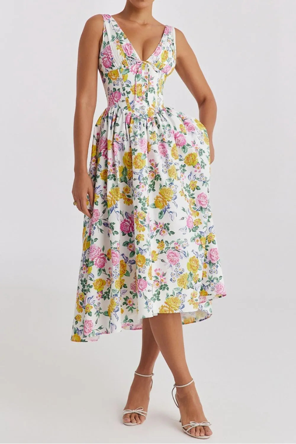 Woman wearing a floral vibrant multicolor midi dress with pockets on a white background