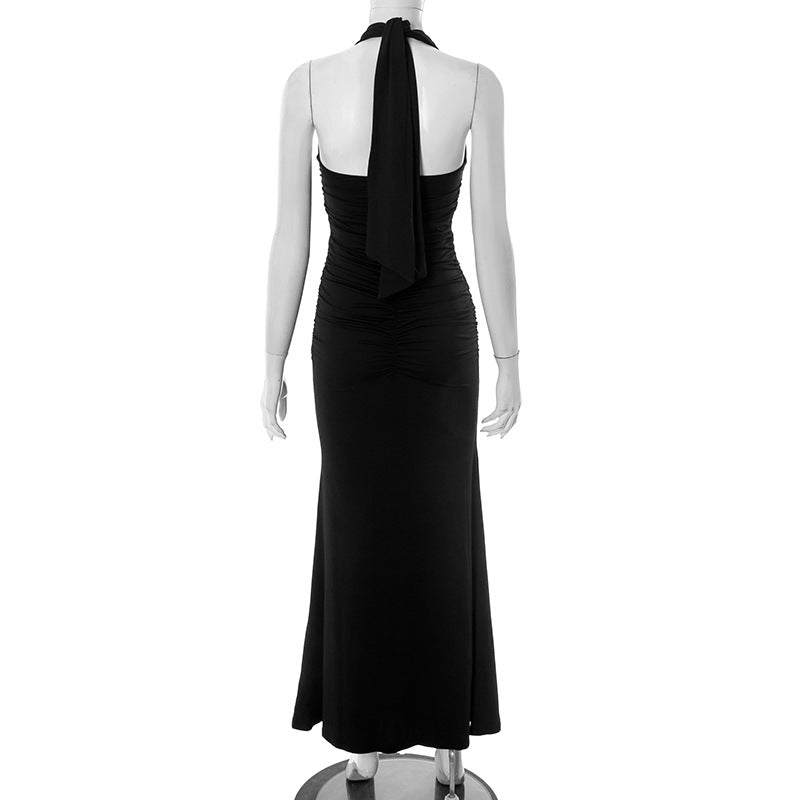 Back of black halter neck maxi evening party dress on a mannequin against a white background