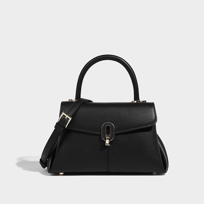 A black leather satchel mini handbag with a structured design, featuring a buckle closure, a hand handle, and a detachable strap.
