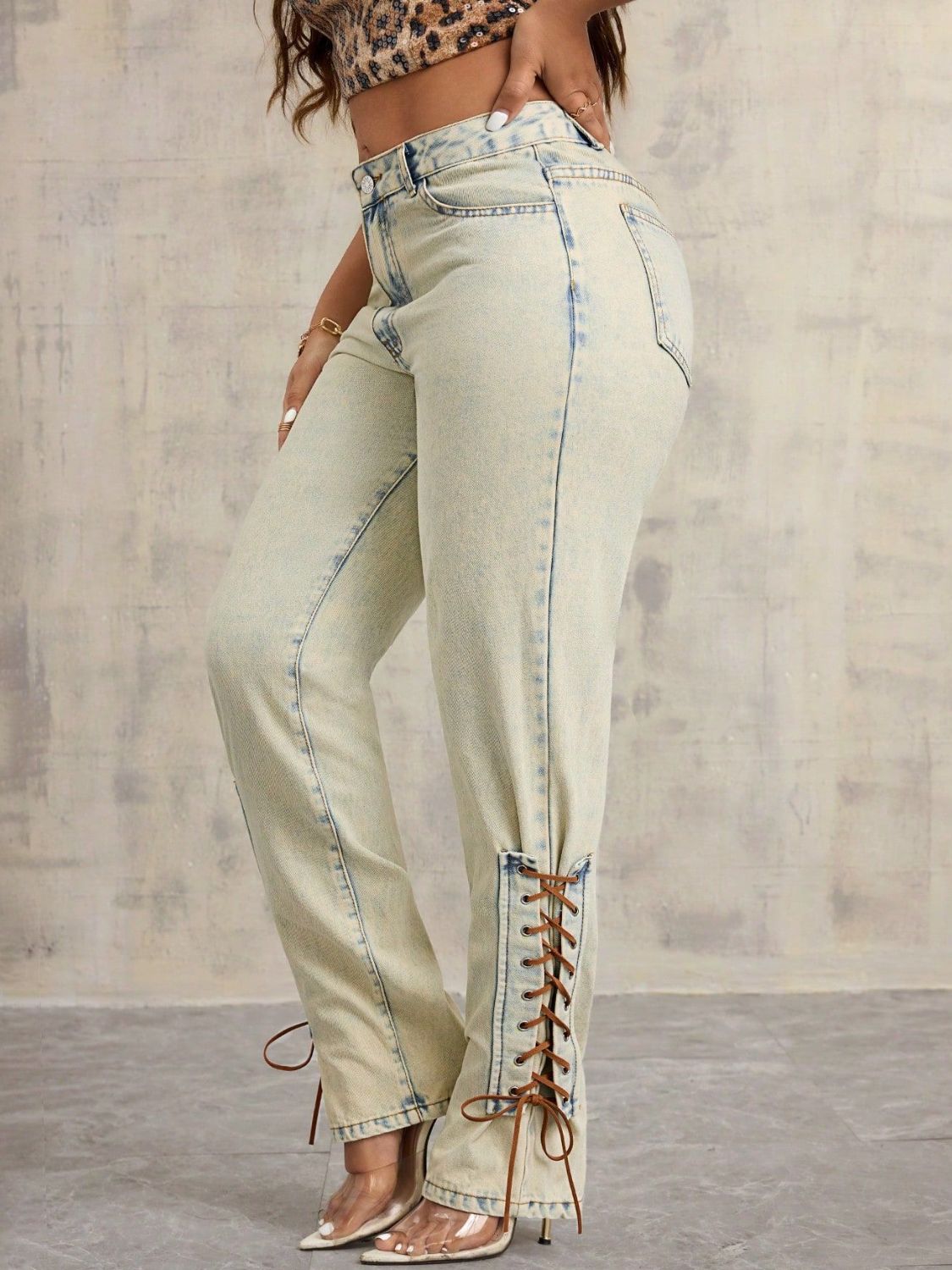 Model wearing vintage wash lace up denim side view