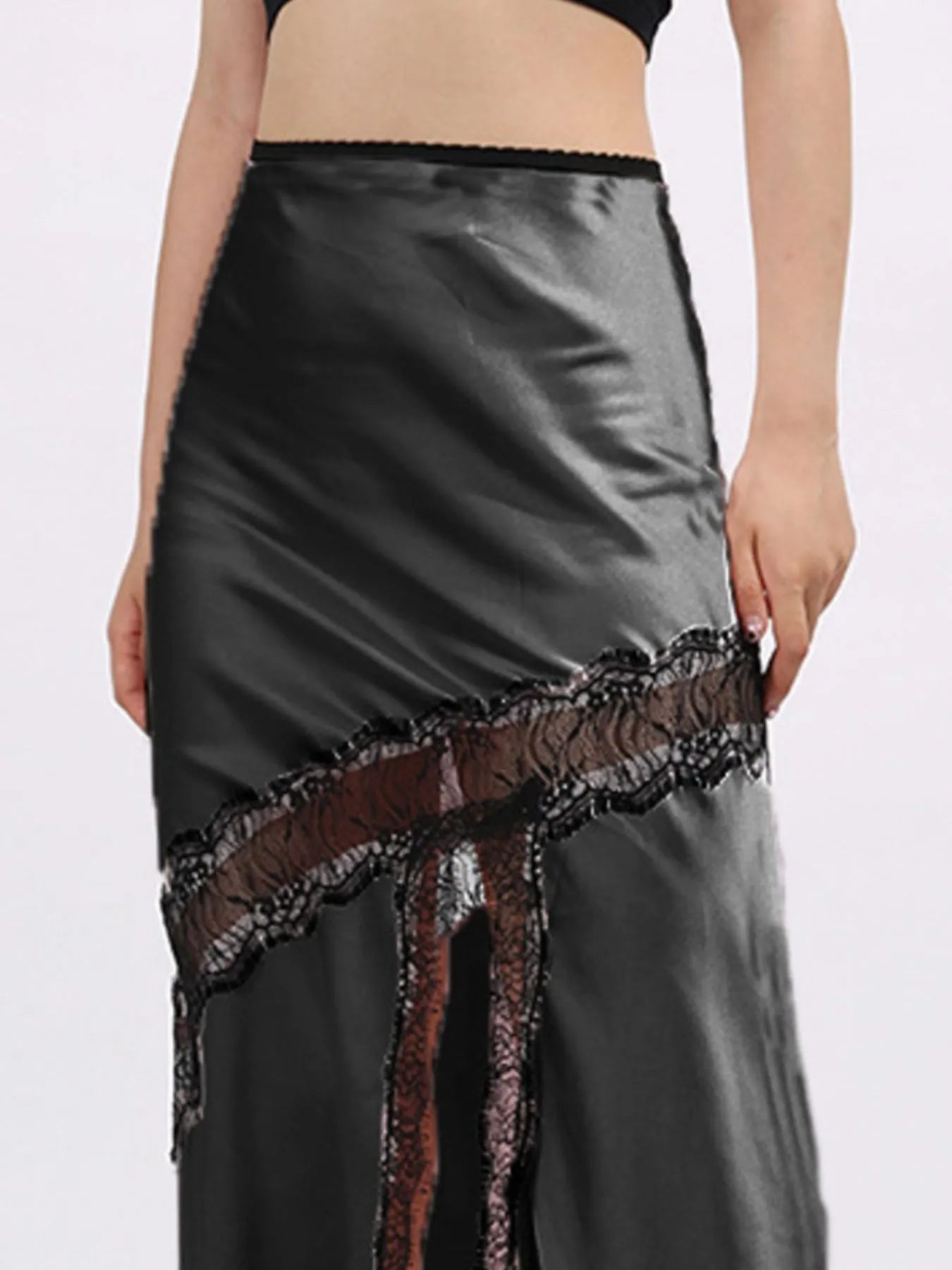 Black satin high fashion asymmetrical midi skirt with lace trim on a white background
