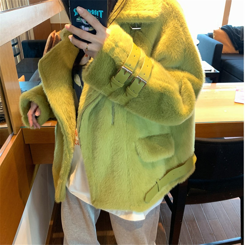 Woman wearing a high fashion oversized faux fur coat with buckle closures
