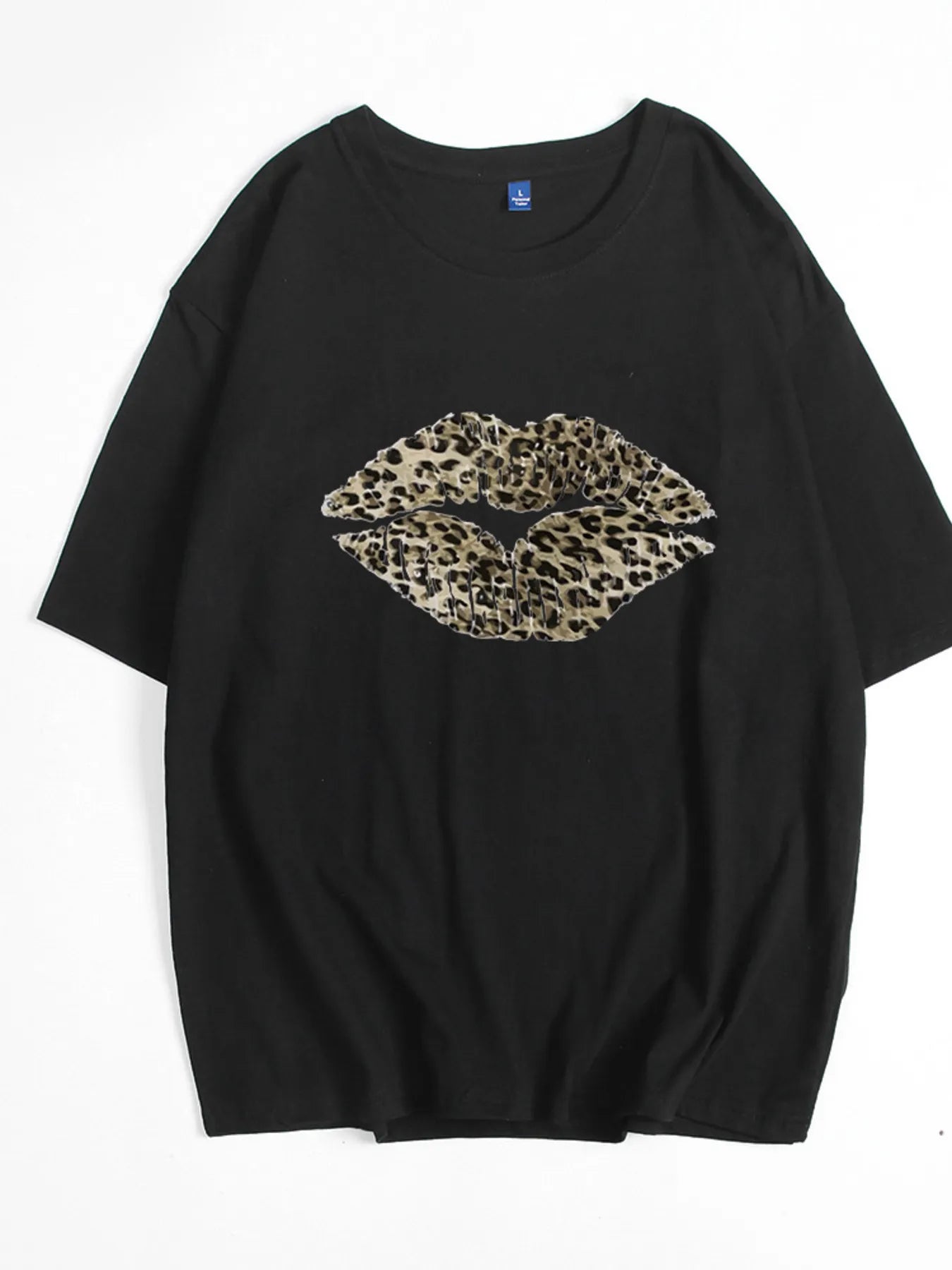 Black leopard print lip graphic tee flat lay on white background