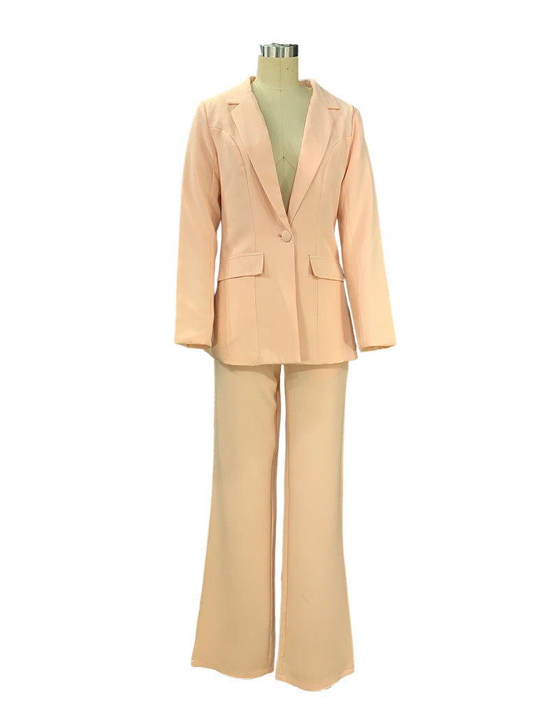 Light pink two piece tailored pant suit for women on a mannequin