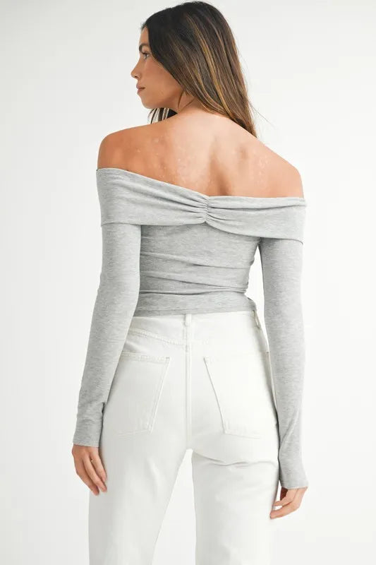 Model in off-shoulder long sleeve gray knit top with relaxed silhouette back view