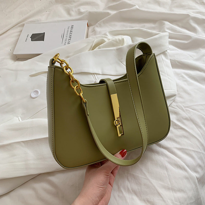Green minimalist shoulder bag with gold chain strap detail