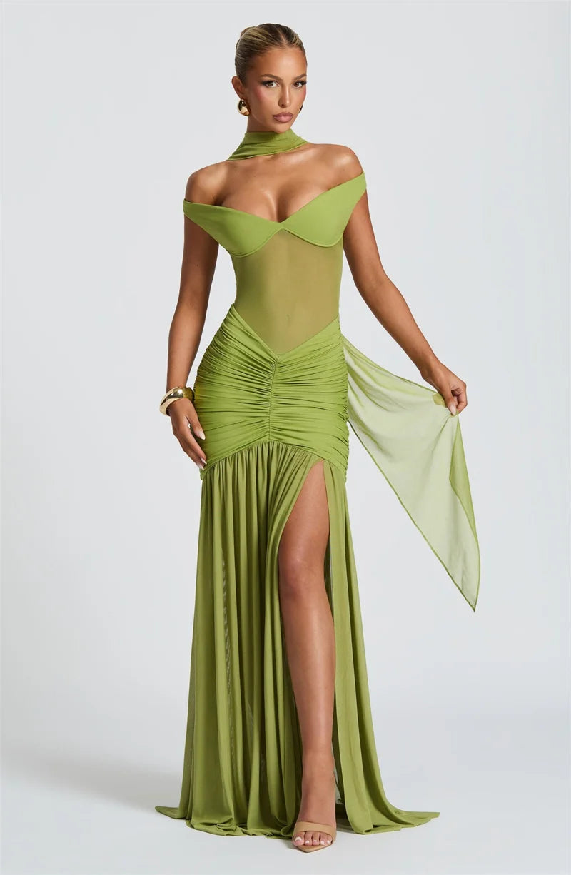 Woman in a green off shoulder backless split maxi dress front view