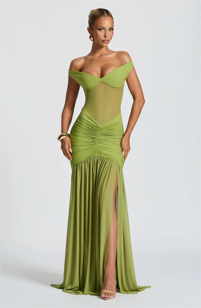 Woman in a green off shoulder backless split evening dress front view