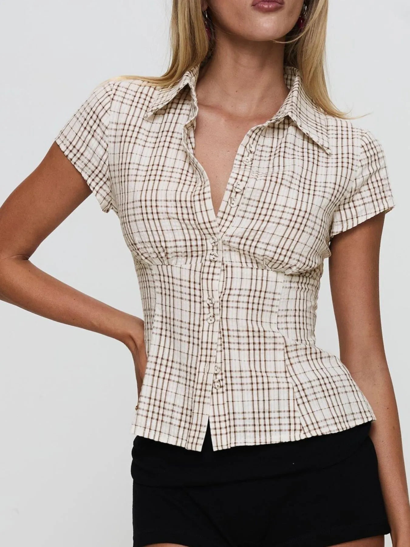 Model in plaid khaki short sleeve button-up shirt with relaxed fitted look front view