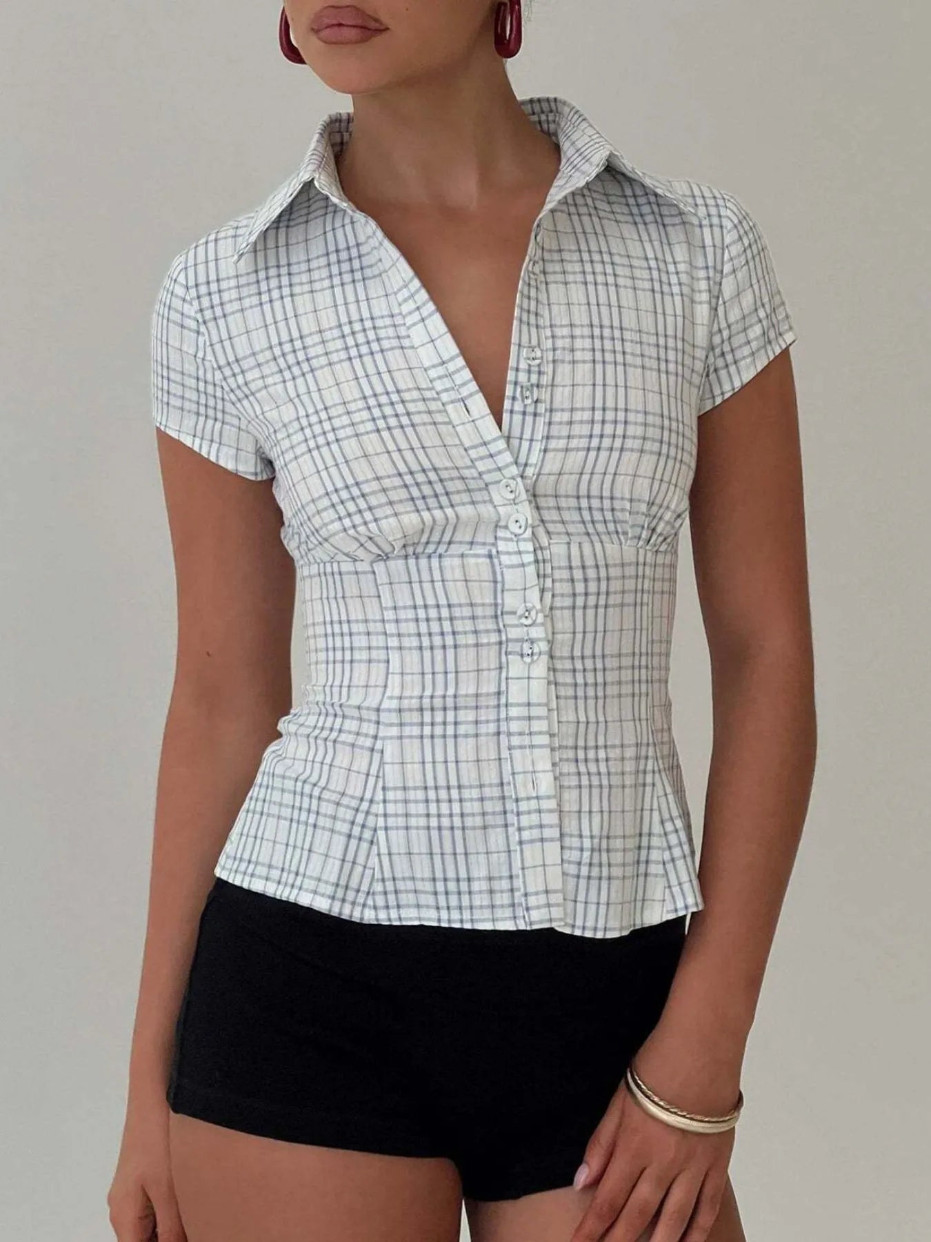 Model in plaid blue short sleeve button-up shirt with relaxed fitted look front view