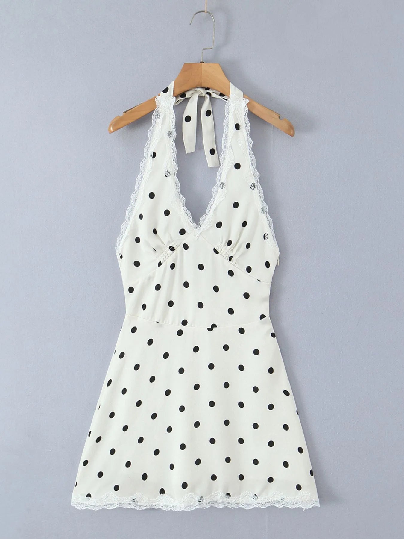 Polka dot halter mini dress with lace trim and open back front view