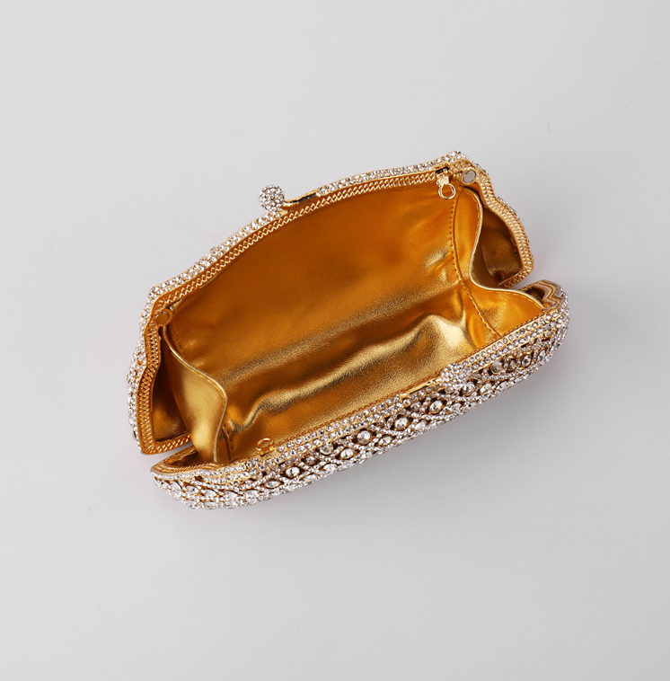 Elegant gold clutch with structured design and clasp top inside view on a white background