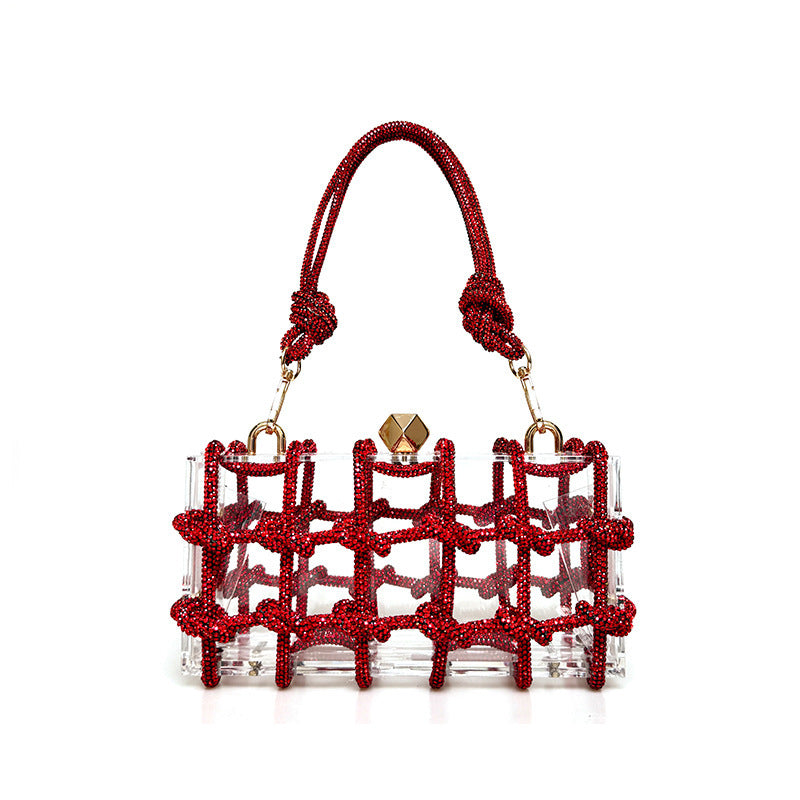 A shiny red rhinestone-encrusted acrylic clear handbag in a square shape with a single shoulder strap and gold-colored hardware.