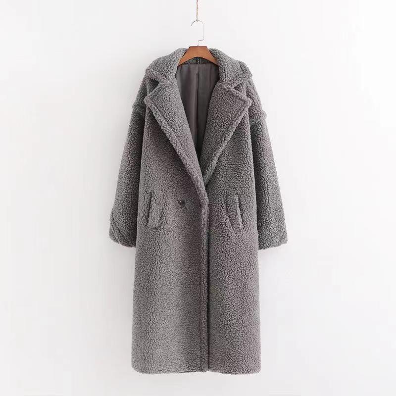 A long gray/grey plush teddy coat with long sleeves, front buttons and pockets displayed on a hanger against a white background.