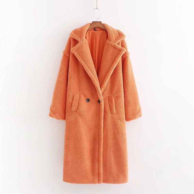 A long orange plush teddy coat with long sleeves, front buttons and pockets displayed on a hanger against a white background.