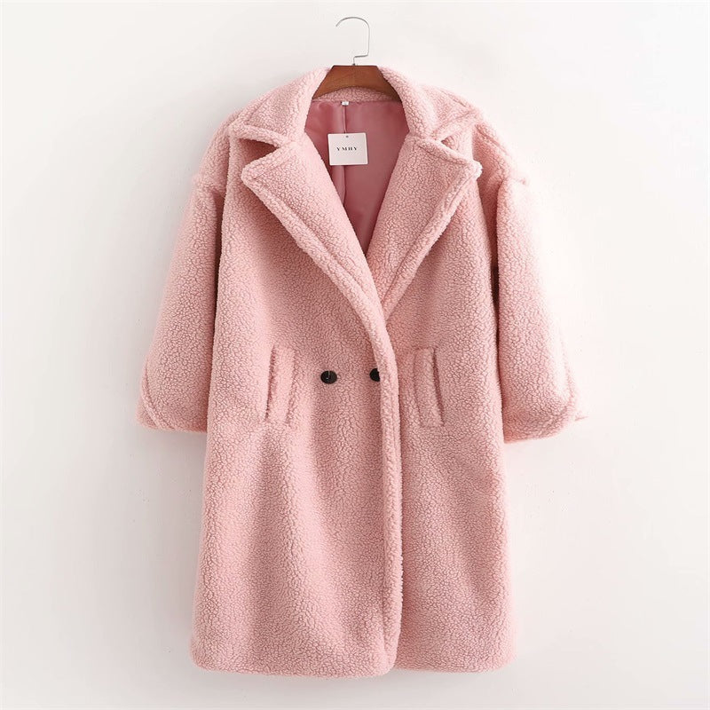 A pink plush teddy coat with long sleeves, front buttons and pockets displayed on a hanger against a white background.