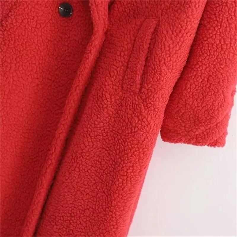 Close-up of pocket and long sleeve of a red plush teddy coat for women on a white background