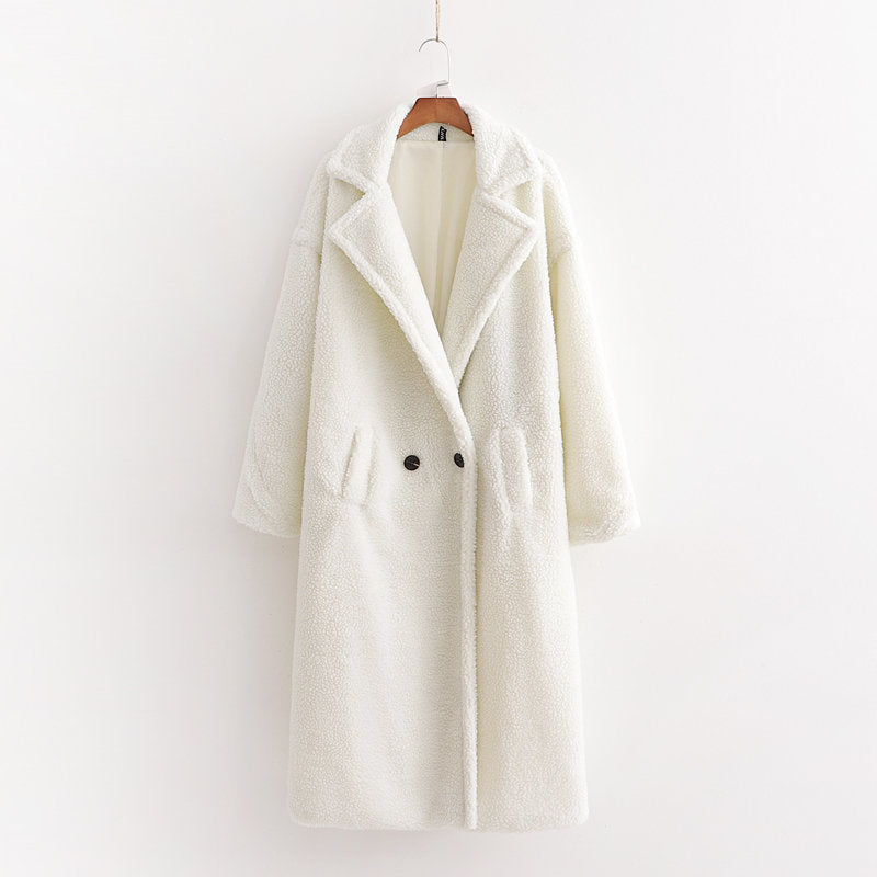 A long white plush teddy coat with long sleeves, front buttons and pockets, displayed on a hanger against a white background.