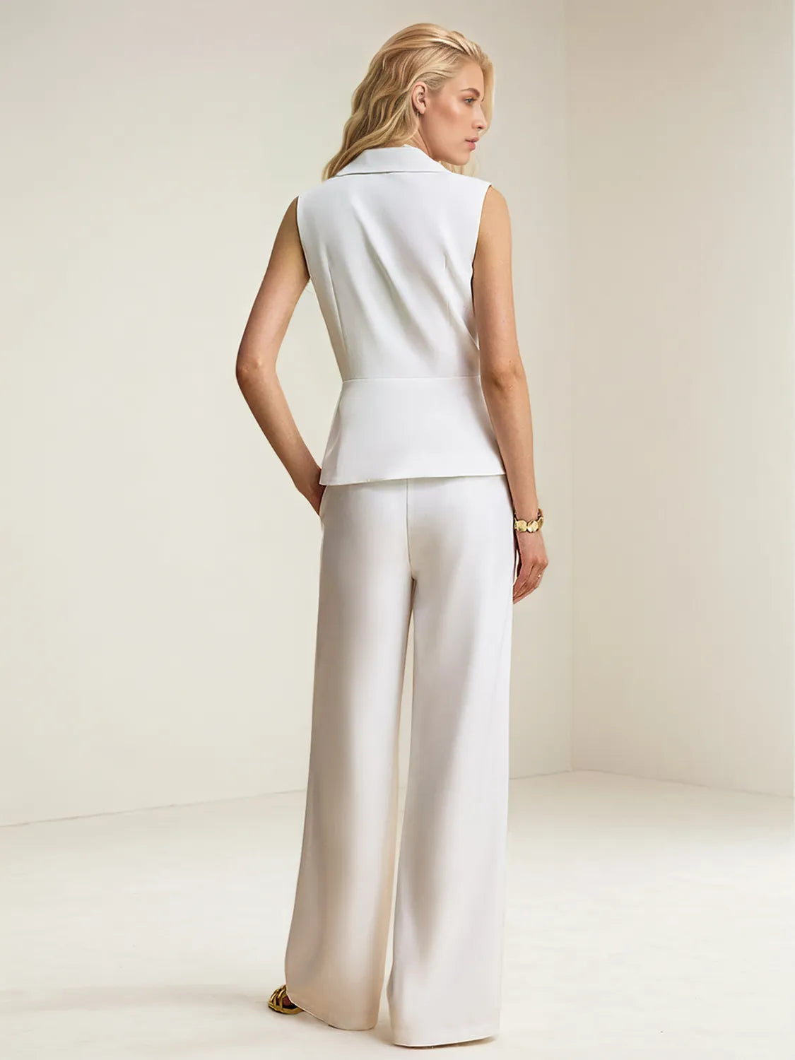 Back view of woman wearing a white Two-Piece Button-Up Vest and Wide-Leg Pants Suit Set on a plain background