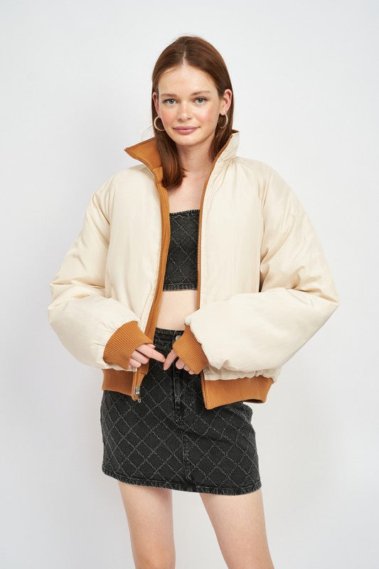 reversible puffer jacket for women on a model front view with front zipper closure and stand up collar