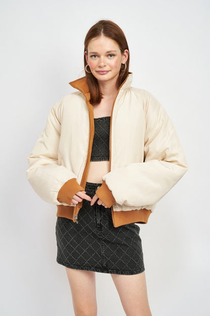 reversible puffer jacket for women on a model front view with front zipper closure and stand up collar