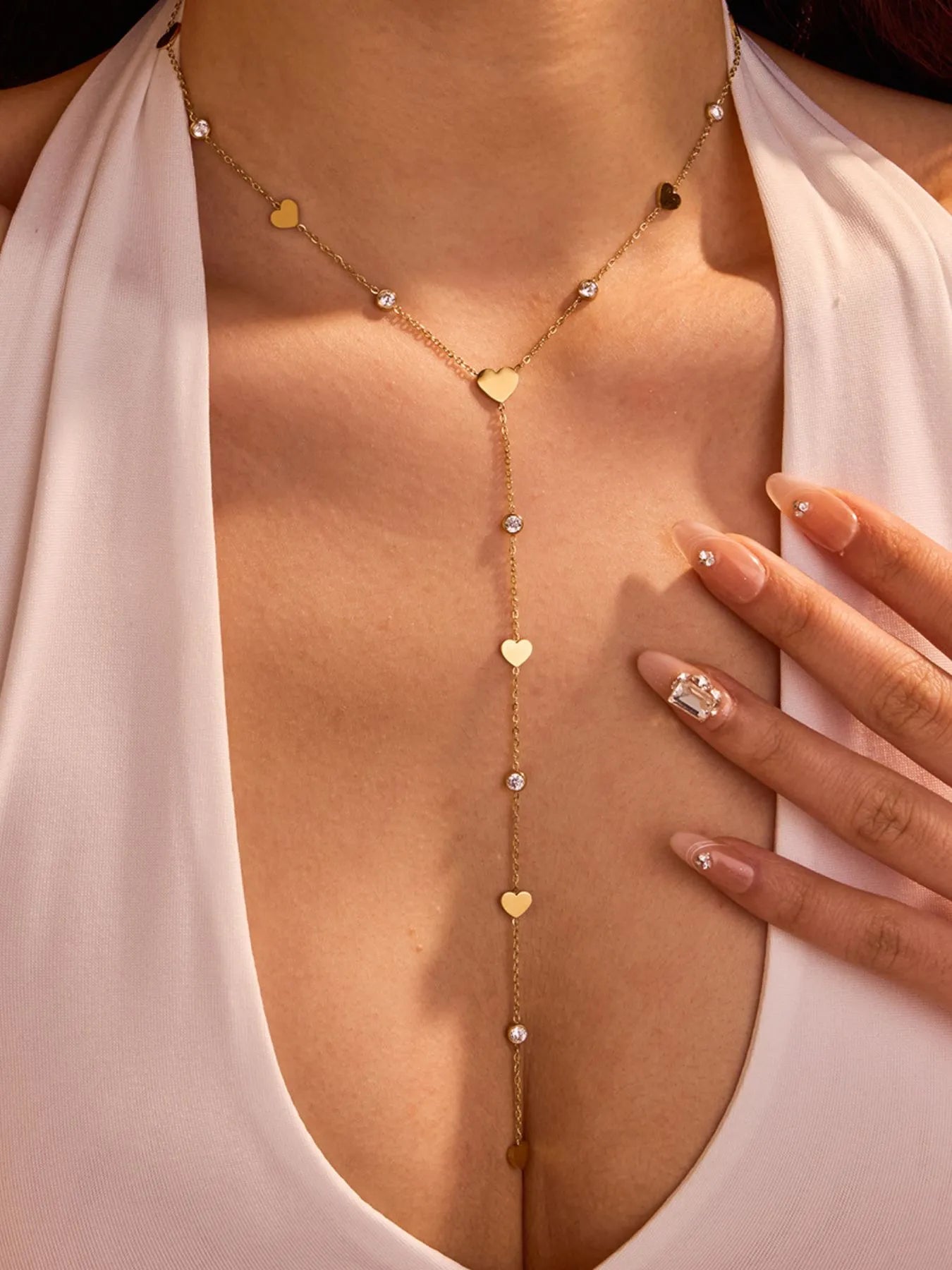 Woman wearing 18K gold plated heart zircon necklace with crystal charm 