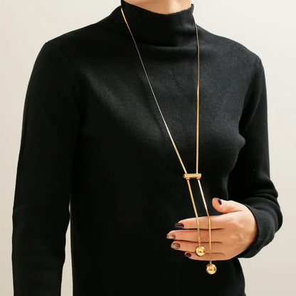 Woman wearing 18K gold plated hollow bead necklace in titanium steel