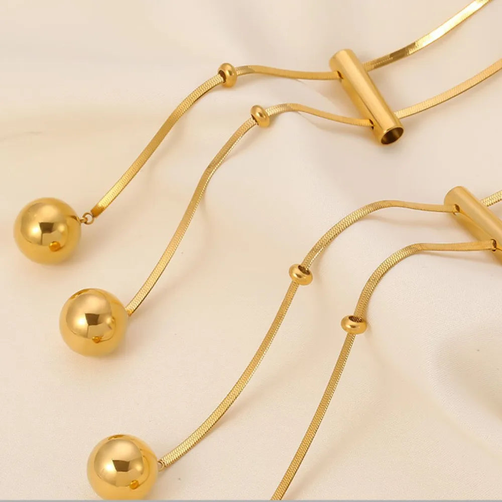 Close up of 18K gold plated hollow bead necklace in titanium steel