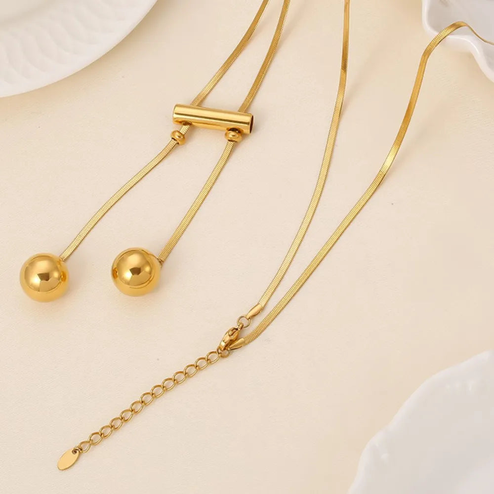 Close up of 8K gold plated hollow bead necklace in titanium steel showing clasp
