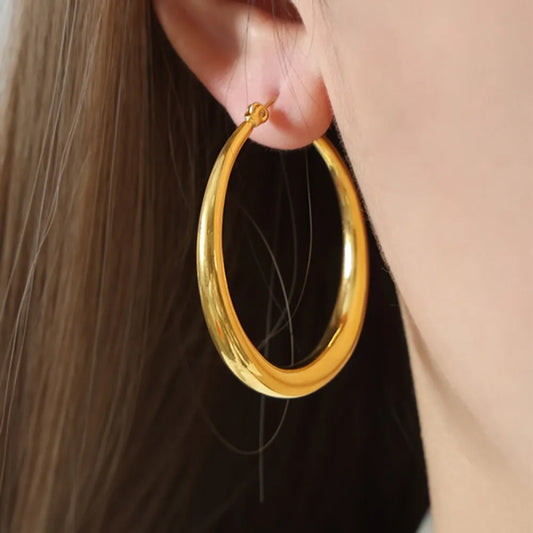 Woman wearing 18K gold-plated stainless steel hoop earrings for everyday wear front view