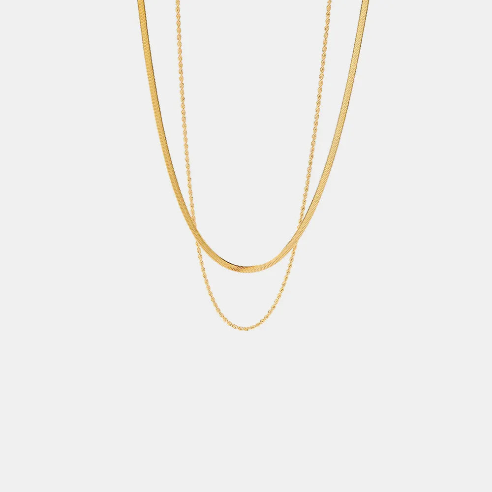 Minimalist gold chain necklace with two delicate layers on white background