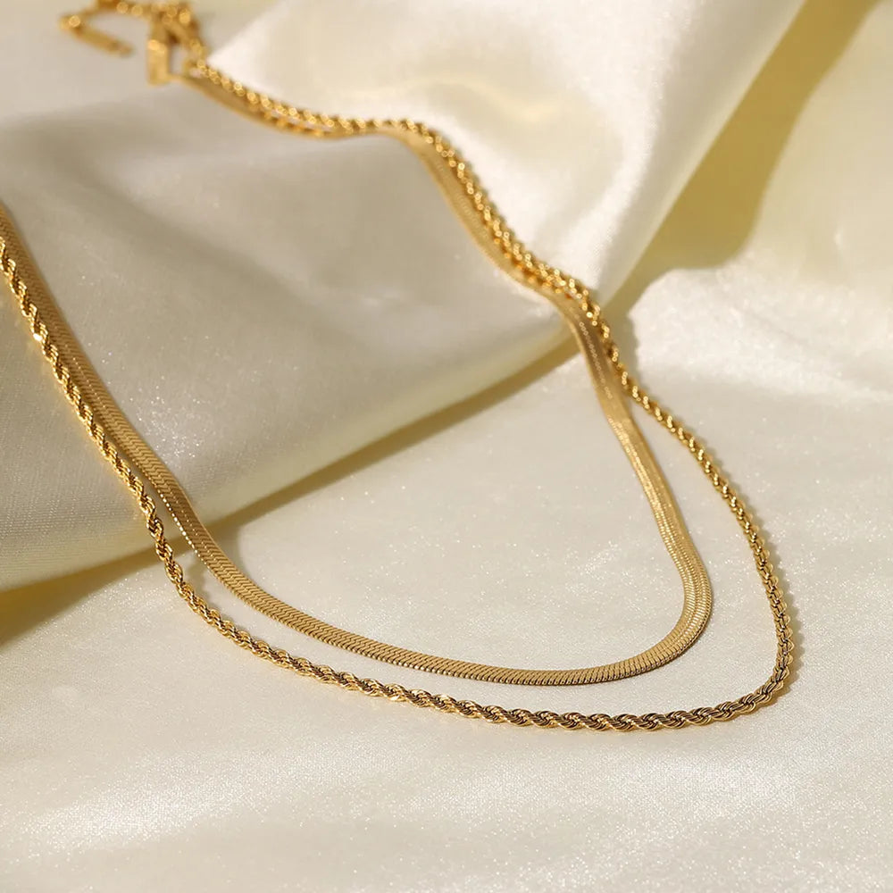 18K gold plated double layered necklace for women on satin fabric close up 