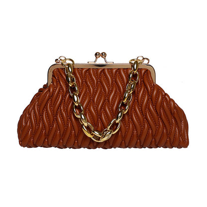 Brown textured leather clutch handbag with gold chain handle on a white background