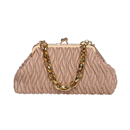 Beige textured leather quilted handbag with a gold chain handle on a white background
