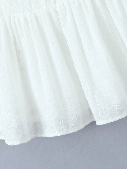 Close-up of lace mini dress in white hem and fabric texture 