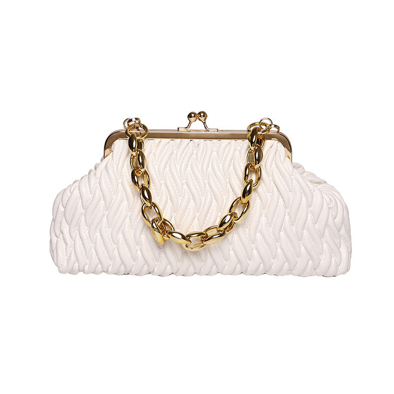 White textured leather clutch with gold chain handle on a white background
