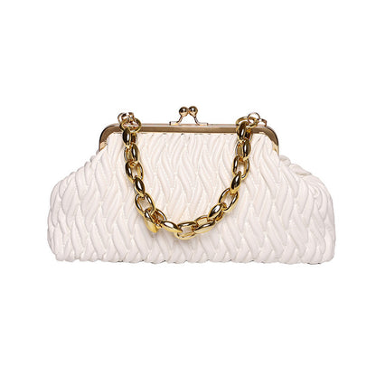 White textured leather clutch with gold chain handle on a white background