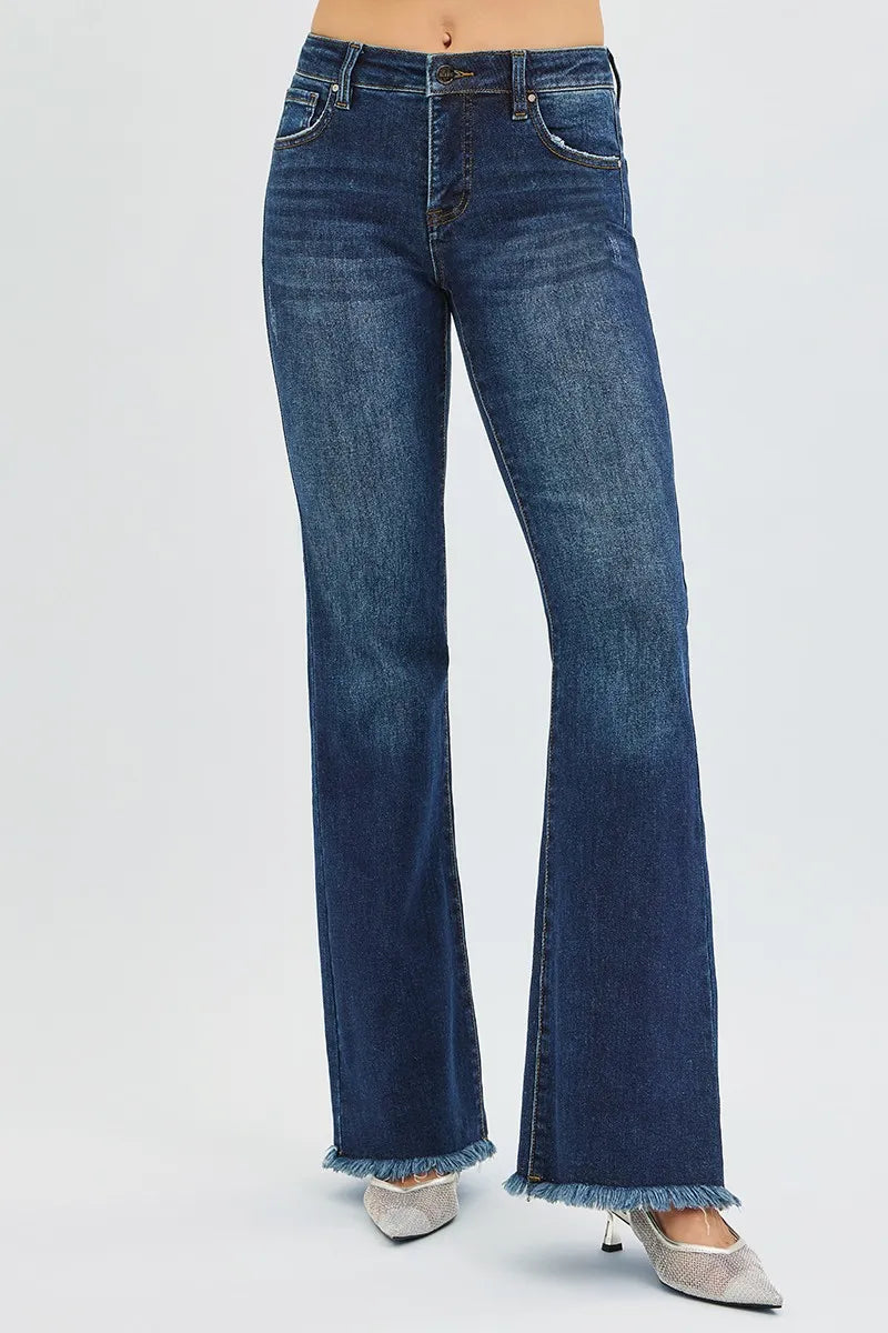 woman wearing dark wash blue denim mid rise flare leg tummy control jeans for women