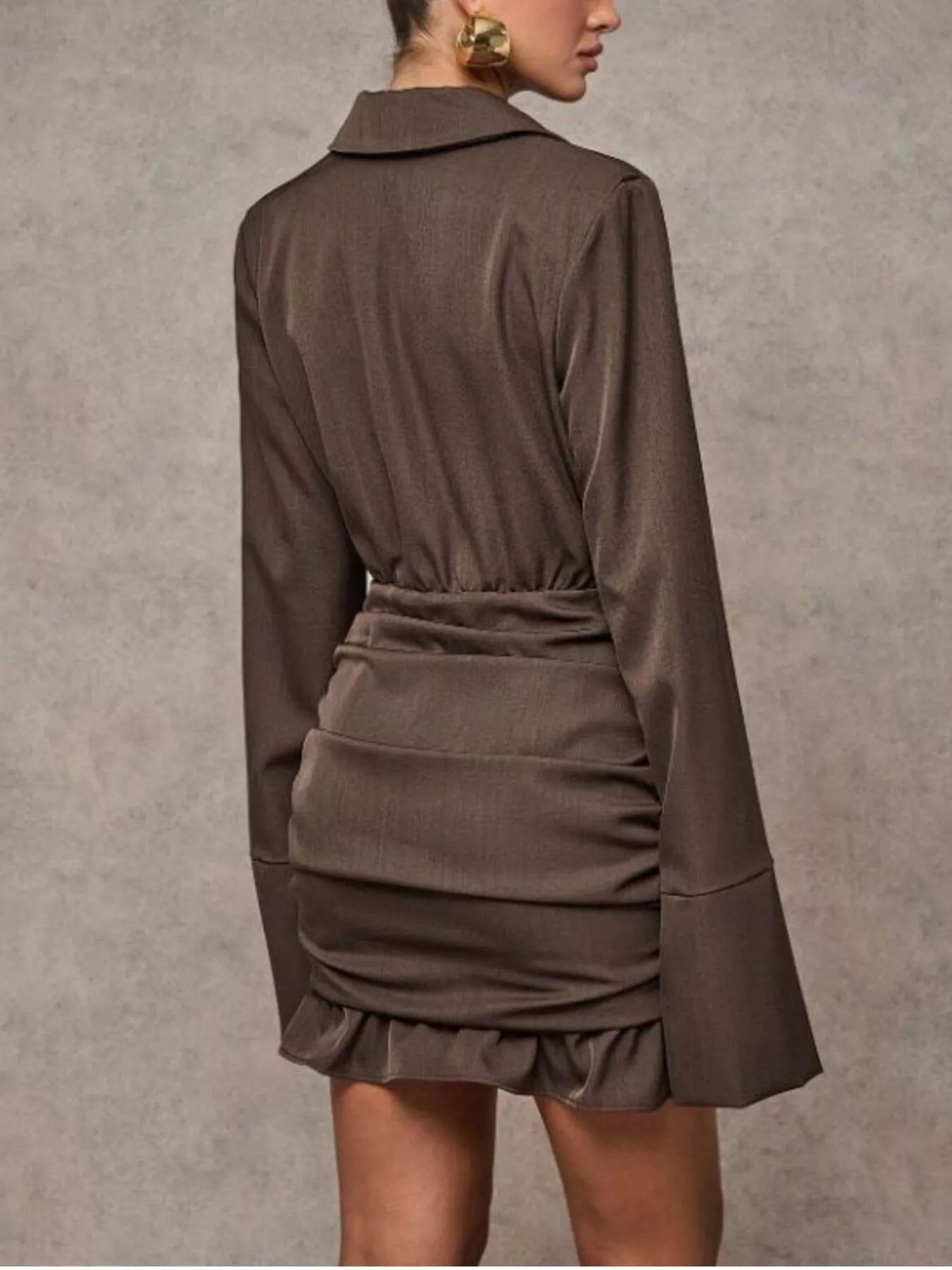 Brown blazer style ruffled mini dress with long sleeves on a neutral background on a woman  back view