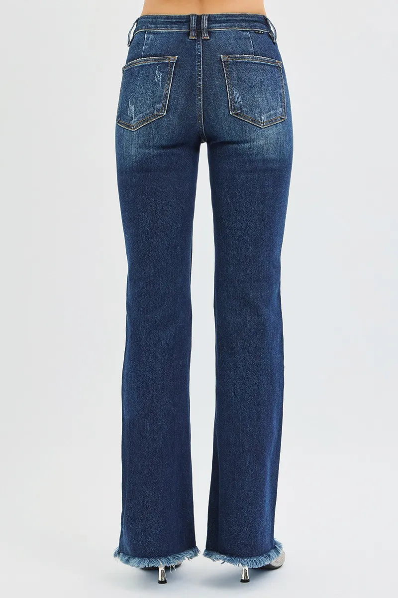 Back view of woman wearing dark wash blue denim mid rise flare leg tummy control jeans 