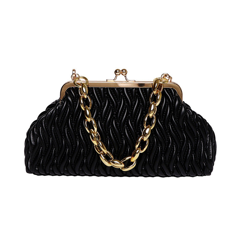 Black textured clutch leather handbag with gold chain and frame on a white background