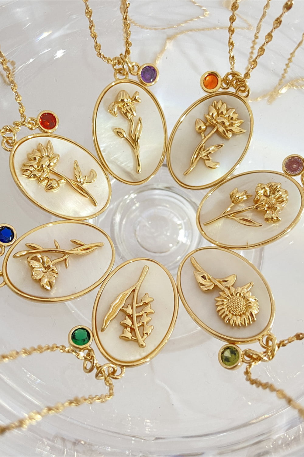 Multiple variations of delicate 14K gold plated pendant necklaces with feminine floral design

