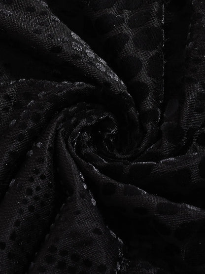 Close-up of black fabric for open back mini summer dress with a subtle pattern