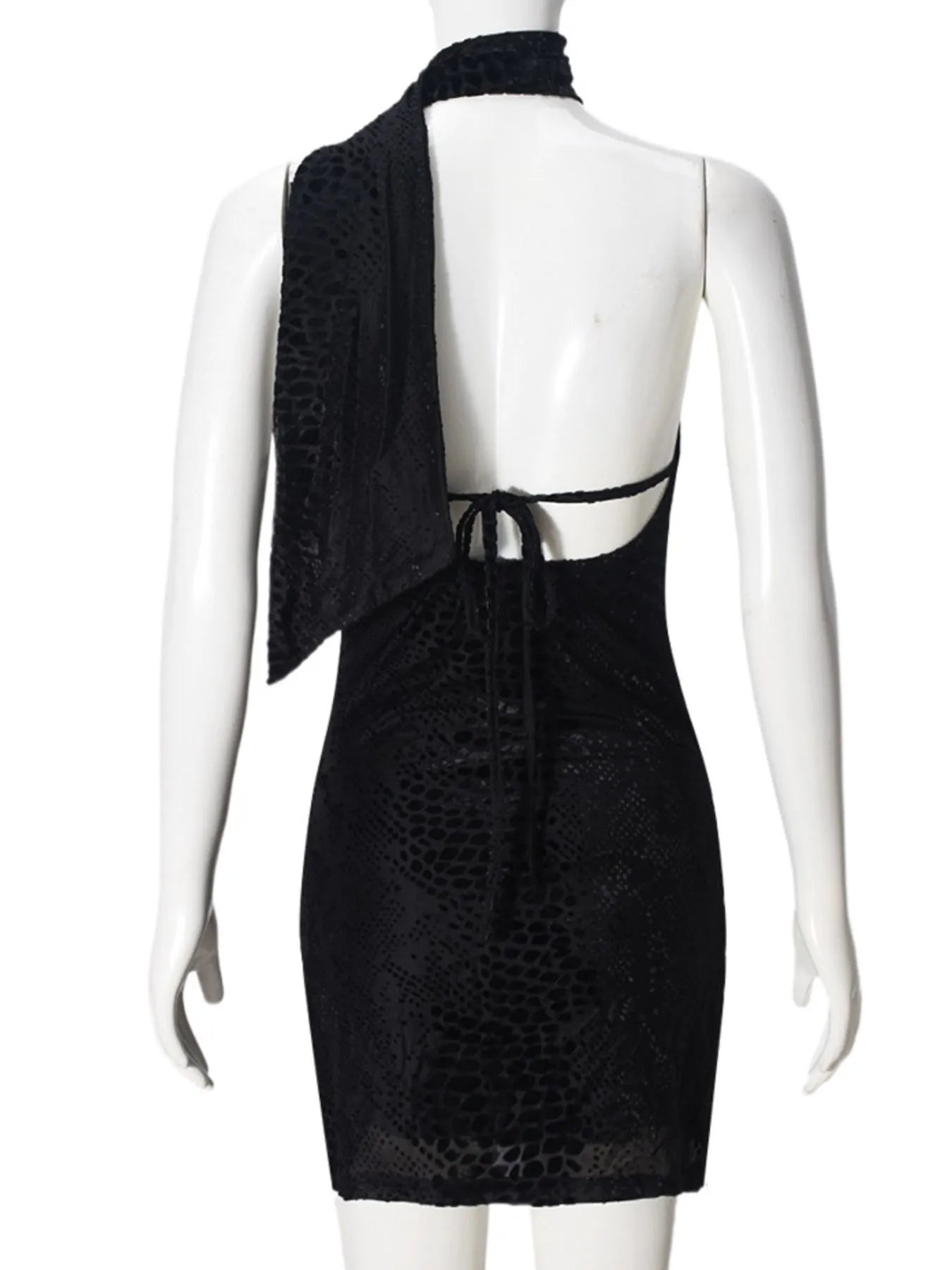 Back view of black asymmetrical halter mini dress with open back on a mannequin against a white background